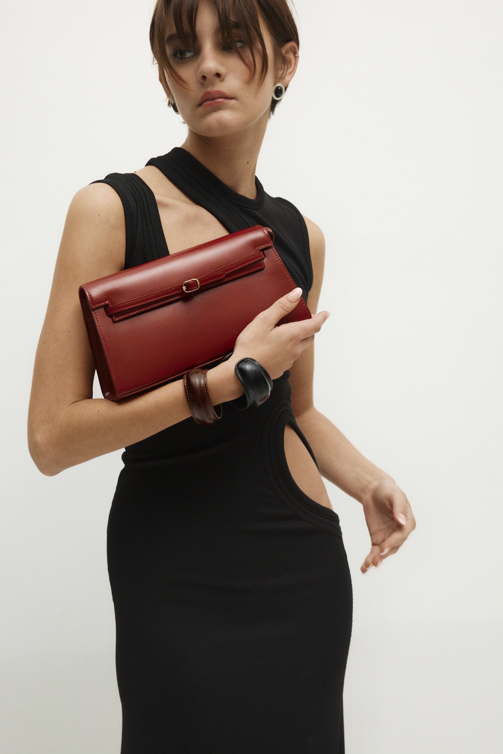 Woman holding a Dark Cherry Shoulder Purse Handbag against a plain background