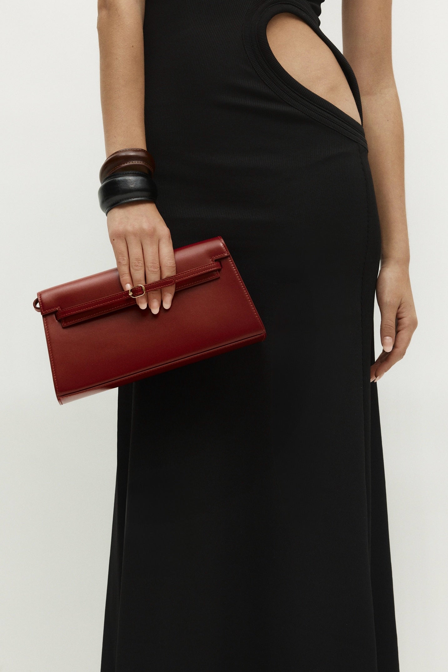 Person holding a Dark Cherry Shoulder Purse Handbag against a plain background