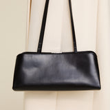 Silver Noir Éclair Clutch Shoulder Handbag (Black) with a strap on a light background