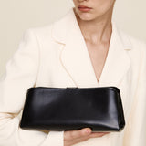 Person holding a Silver Noir Éclair Clutch Shoulder Handbag (Black)  against a neutral background