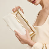 Woman holding a Gold Ivory Éclair Bag: White Clutch Handbag with gold accents against a plain background