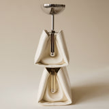 Ceramic coffee grinder with metallic top with two Gold Ivory Éclair Bags: White Clutch Handbags on a beige background