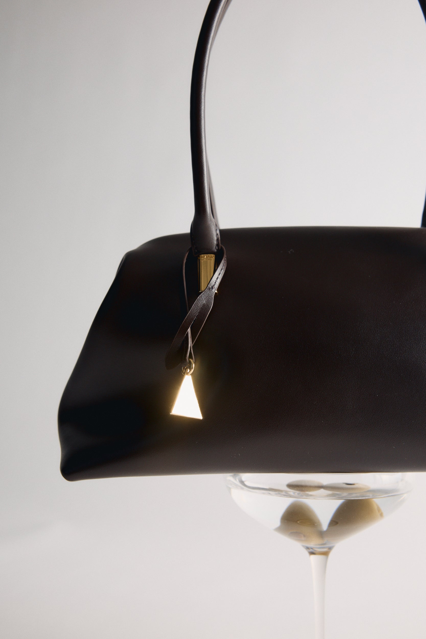 Chocolate Medium Club Shoulder Handbag with a gold handle and clasp on a white background