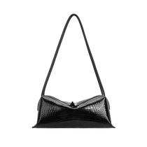 A black crocodile-embossed Black Croc Café Midi East West Bag with a long, slender strap, shown against a solid white background.
