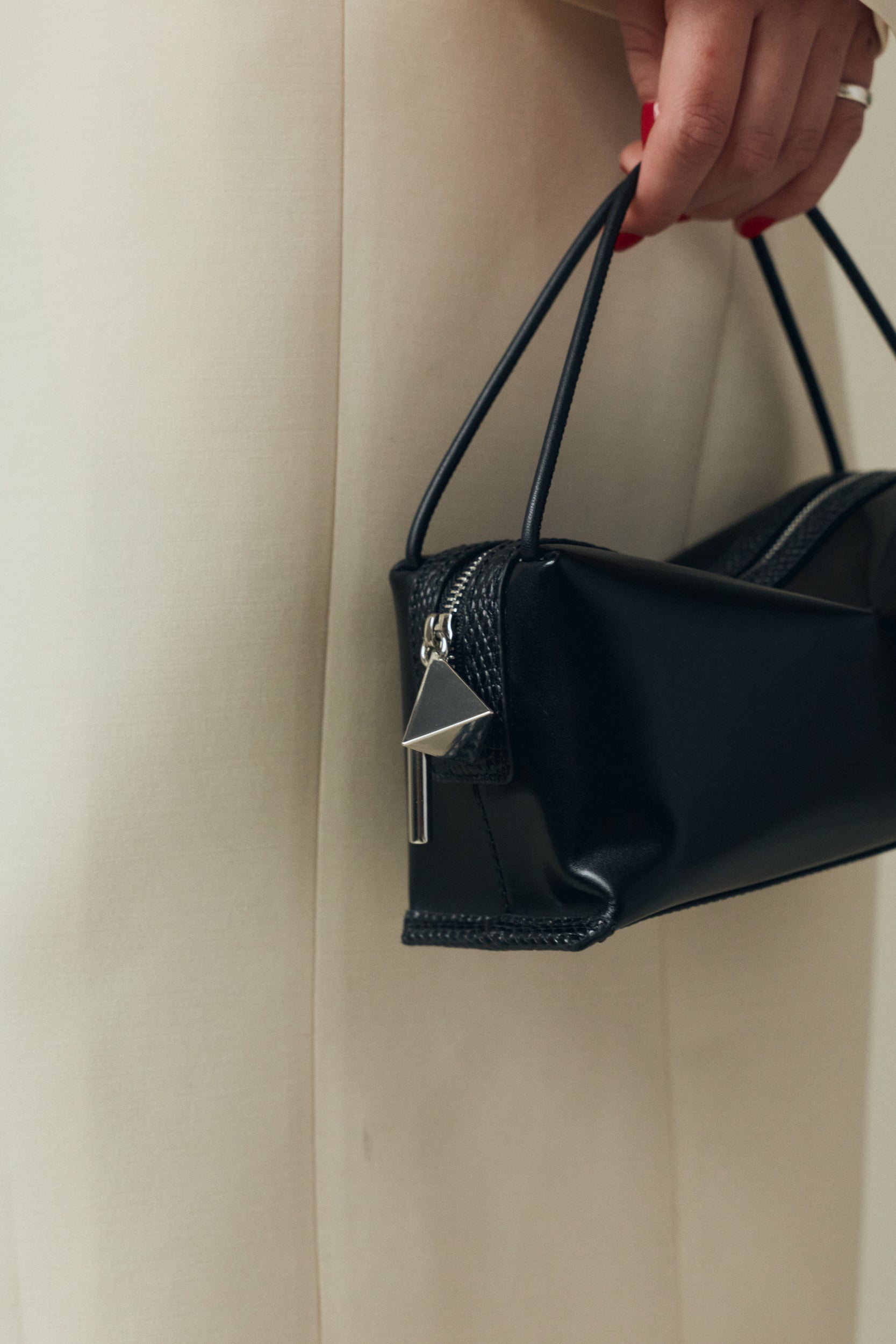 Verafied New York Black Lizard Café Mini Handbag held by a person against a neutral background