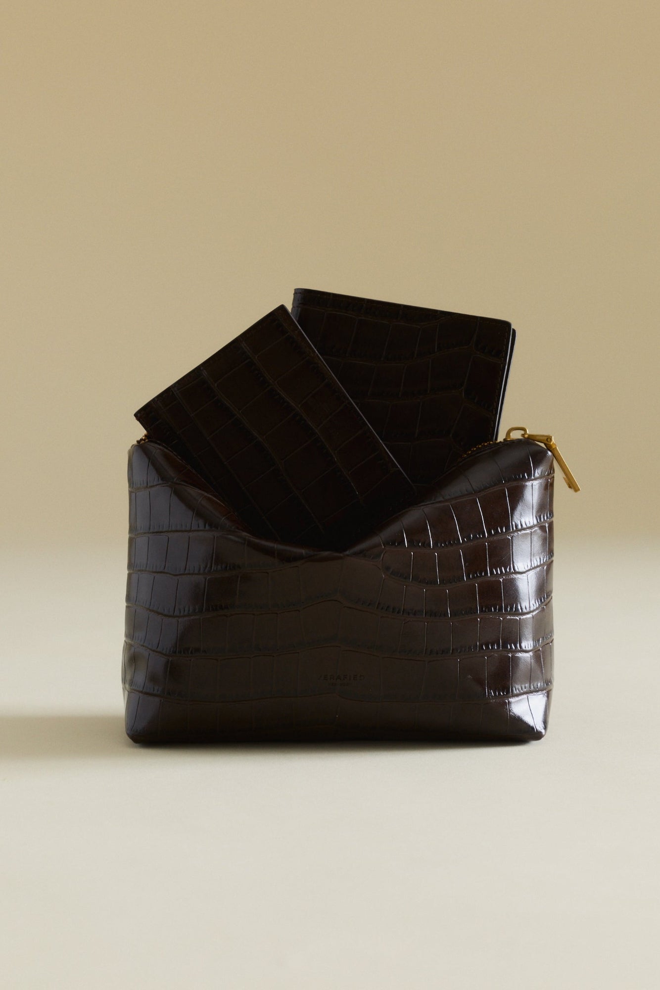Mocha Croc Makeup Pouch bag on a beige background