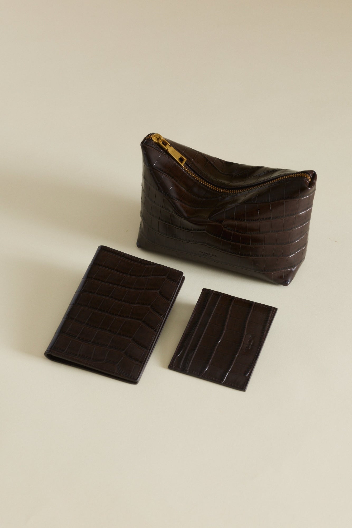 Set of Mocha Croc Makeup Pouches and cardholder on a beige background