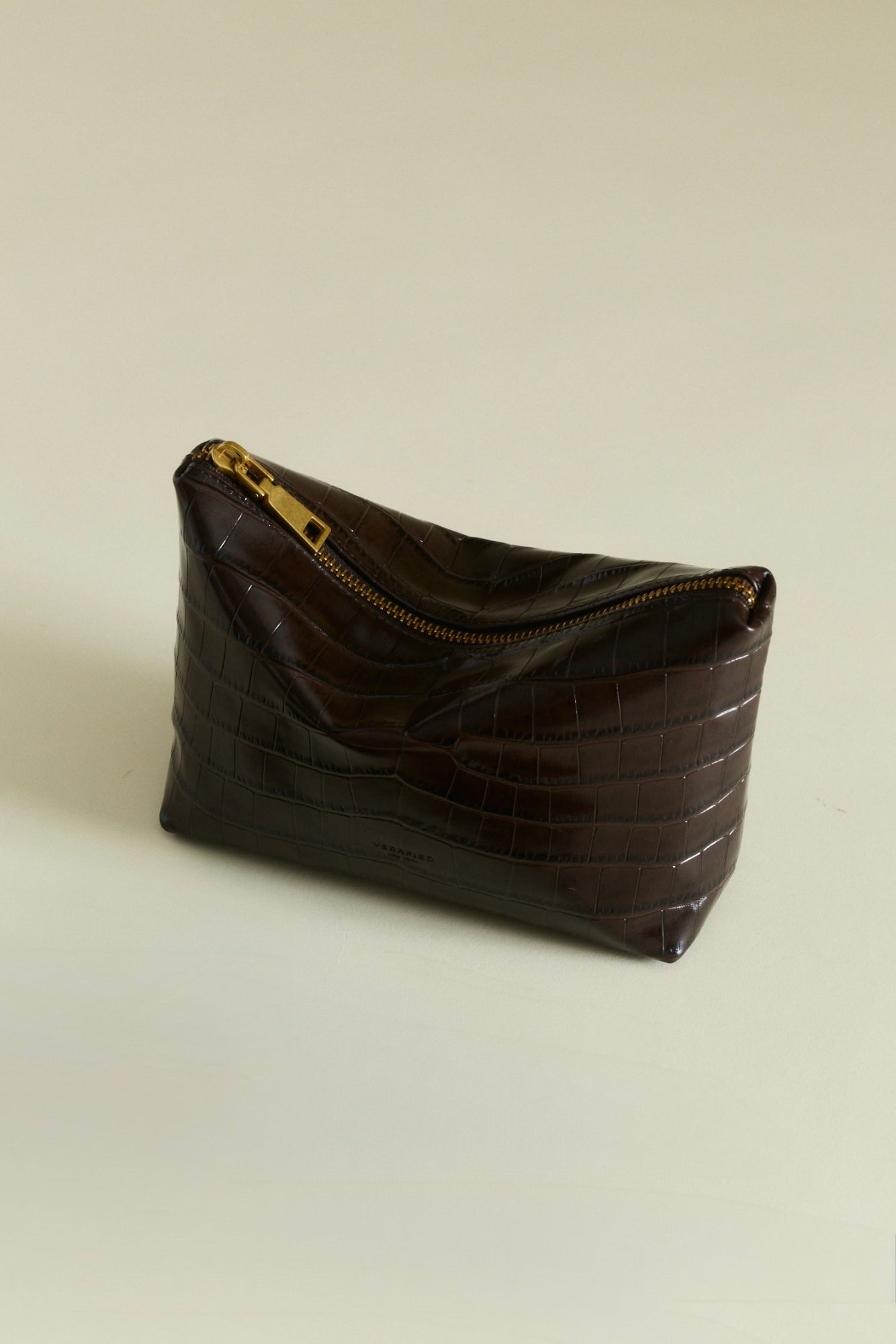 Mocha Croc Makeup Pouch bag on a beige background