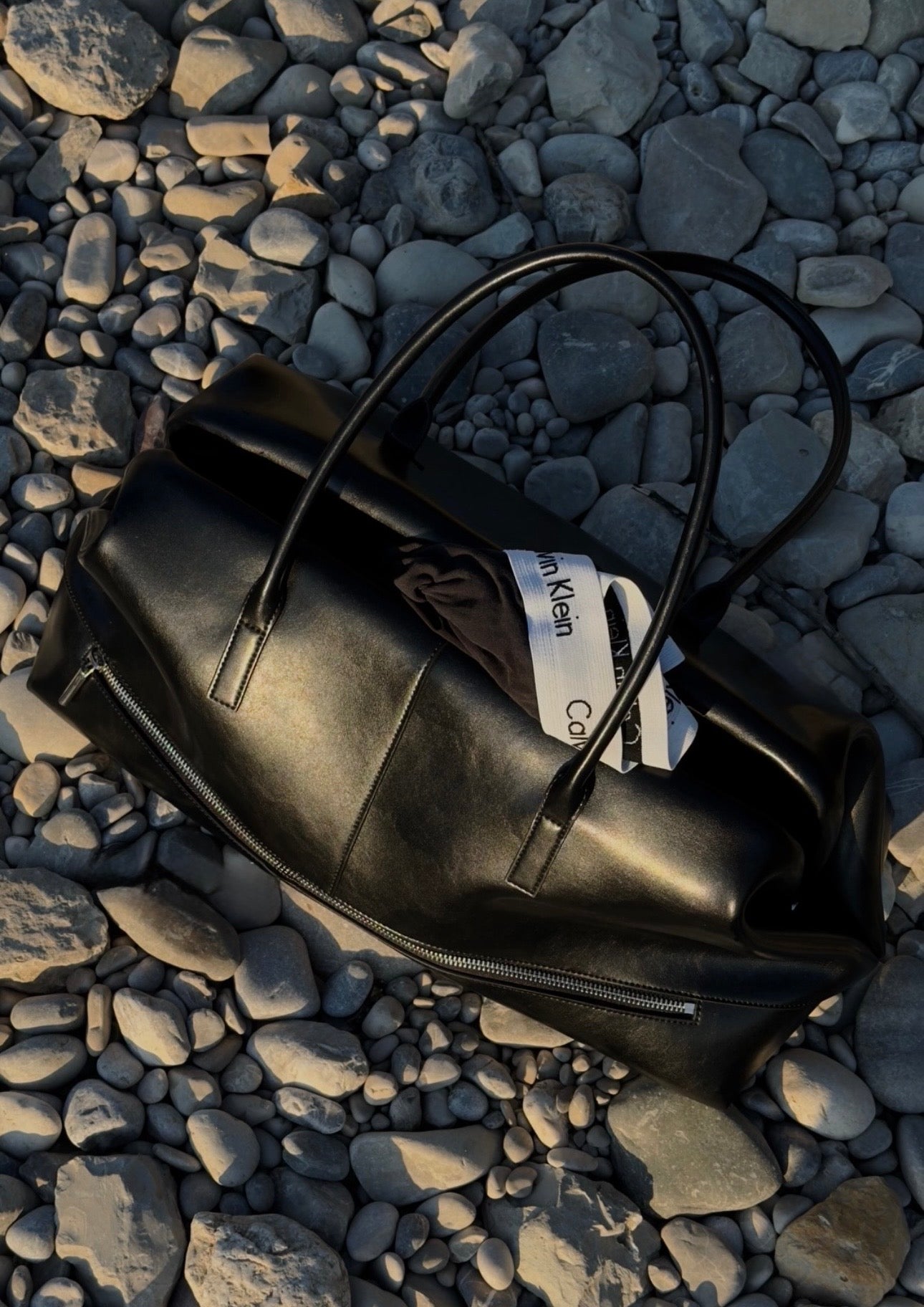 Chocolate Club Bag: Large Everyday Use Bag with a visible brand label on a pebbly surface